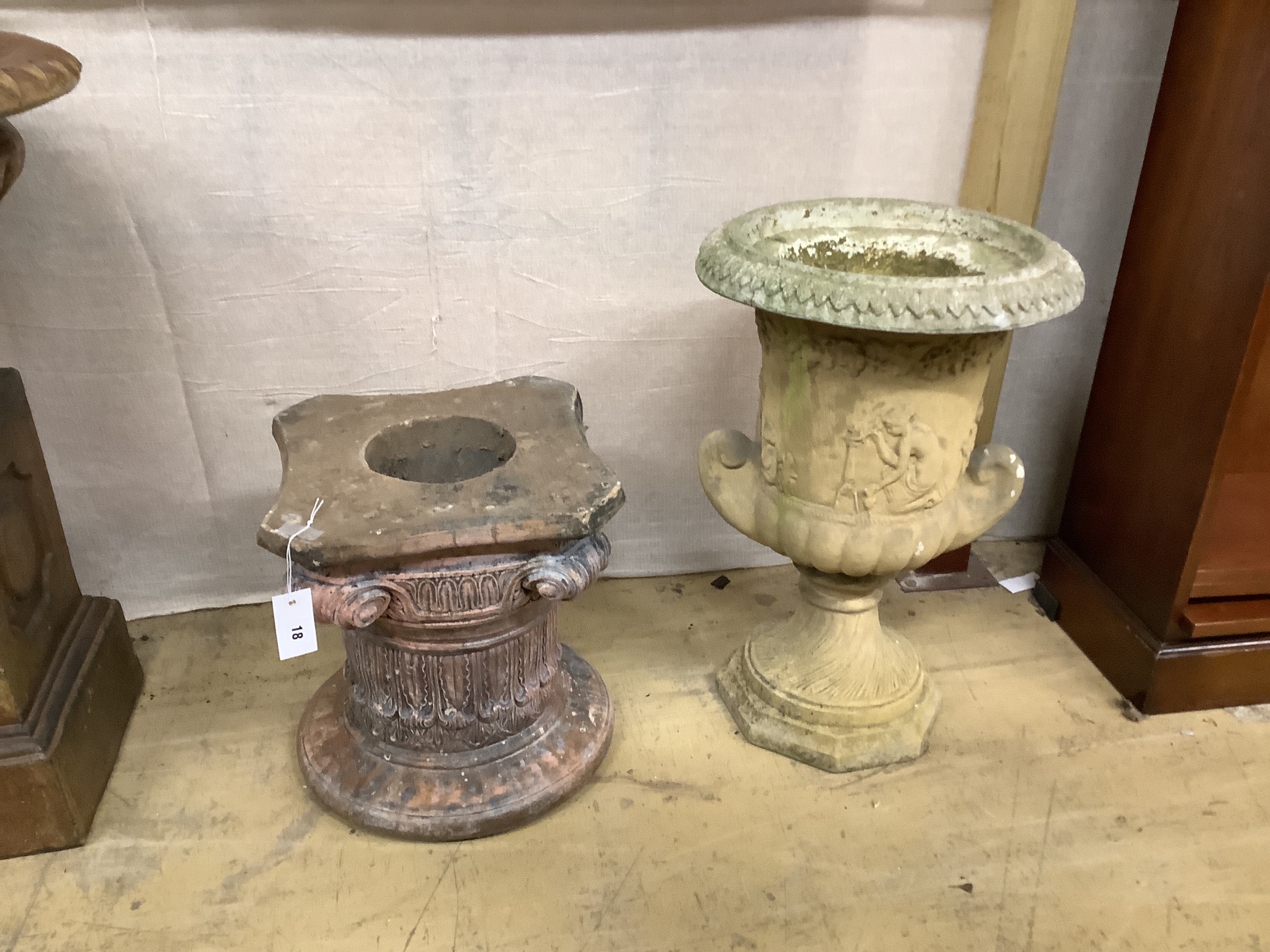 A reconstituted stone garden urn, a.f., height 61cm and an associated pedestal, height 40cm